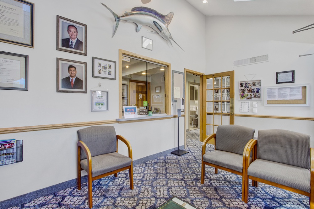 Dental office reception area with patient seating and check-in window