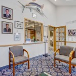 Dental office reception area with patient seating and check-in window