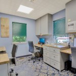Dental laboratory and sterilization area with workstations and cabinetry